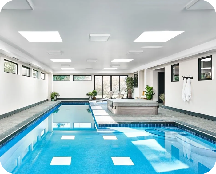 A large indoor swimming pool with white walls.